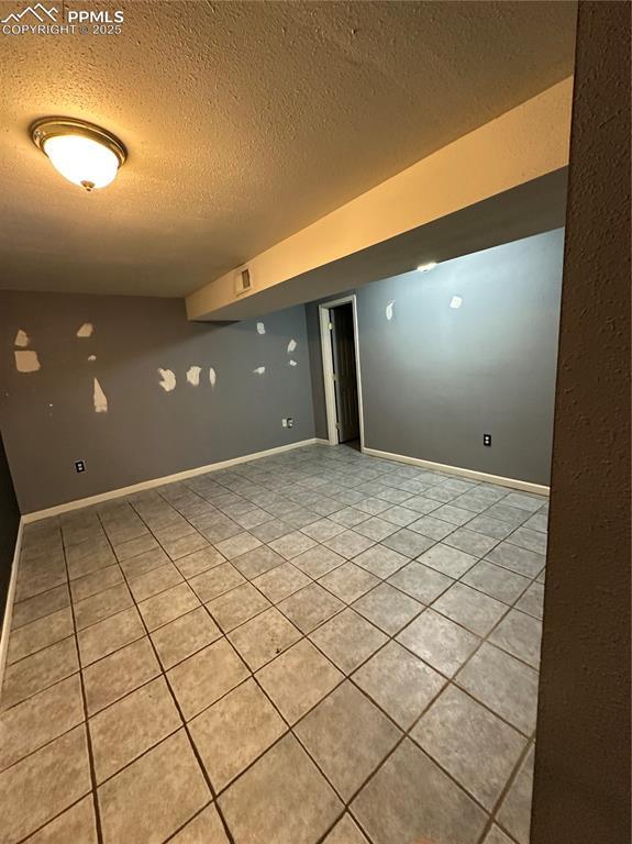 131 Cornell St, Colorado Springs, CO 80911 - finished below grade area with a textured ceiling and light tile patterned floors