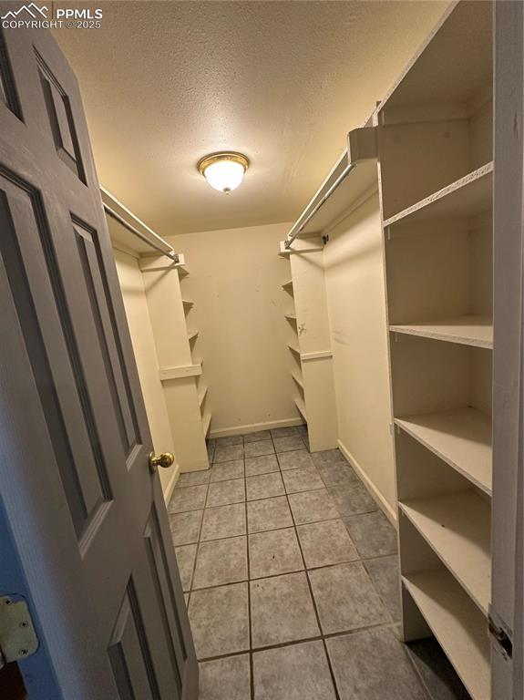 131 Cornell St, Colorado Springs, CO 80911 - spacious closet featuring light tile patterned floors