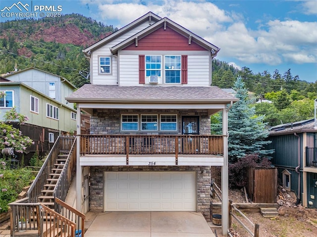 354 Corona Ave, Palmer Lake, CO 80133 - view of front facade featuring stairway, stone siding, driveway, an attached garage, and cooling unit