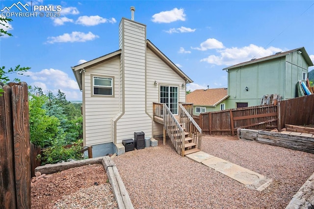 354 Corona Ave, Palmer Lake, CO 80133 - back of house featuring a chimney and a garden
