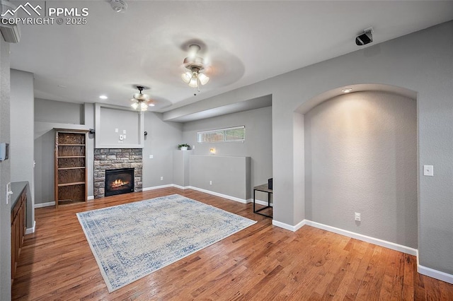 354 Corona Ave, Palmer Lake, CO 80133 - living area featuring a ceiling fan, wood finished floors, and a fireplace