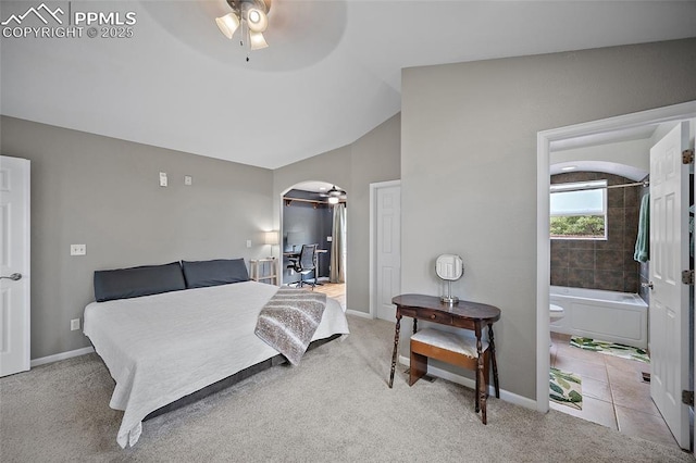 354 Corona Ave, Palmer Lake, CO 80133 - bedroom with arched walkways, carpet, vaulted ceiling, ensuite bathroom, and ceiling fan