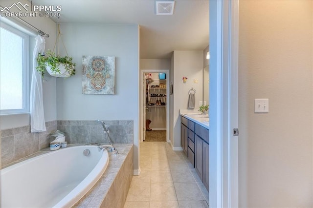 8285 Lodge Grass Way, Colorado Springs, CO 80908 - bathroom with vanity, a bath, tile patterned flooring, a walk in closet, and plenty of natural light