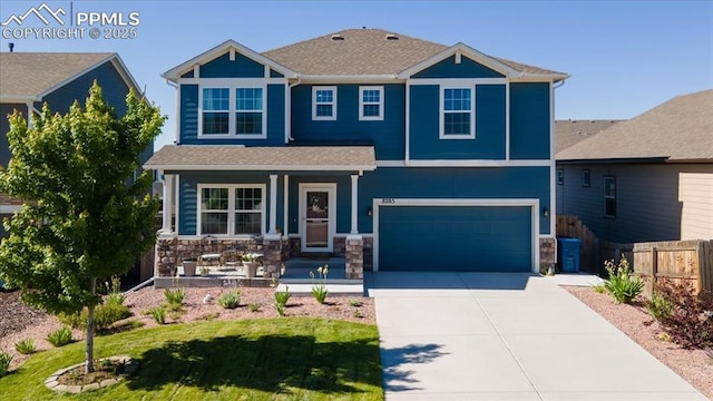 8285 Lodge Grass Way, Colorado Springs, CO 80908 - view of front of property featuring covered porch, an attached garage, driveway, and stone siding