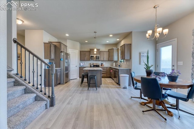 8285 Lodge Grass Way, Colorado Springs, CO 80908 - dining area with light wood-type flooring, a chandelier, stairs, and recessed lighting
