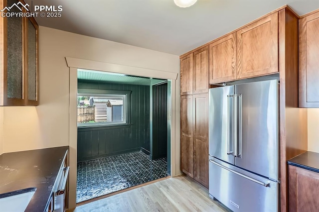 420 E Fontanero St, Colorado Springs, CO 80907 - kitchen with high quality fridge, dark countertops, light wood-style flooring, and brown cabinetry