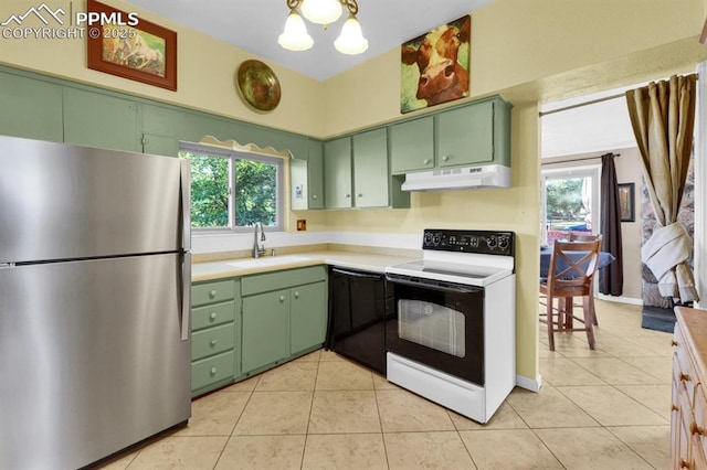 1339 Arch St, Colorado Springs, CO 80904 - kitchen with freestanding refrigerator, range with electric cooktop, green cabinetry, under cabinet range hood, and light countertops