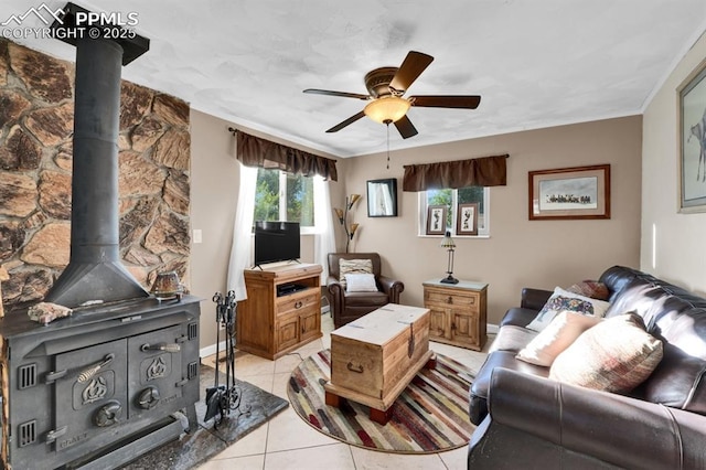 1339 Arch St, Colorado Springs, CO 80904 - living room featuring a wood stove, a ceiling fan, light tile patterned floors, and crown molding