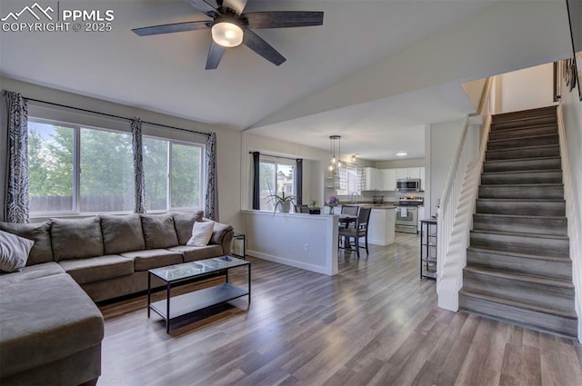 4530 W Jet Wing Cir, Colorado Springs, CO 80916 - living room featuring vaulted ceiling, a ceiling fan, stairs, wood finished floors, and recessed lighting