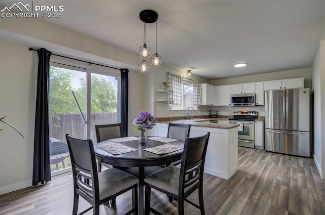 4530 W Jet Wing Cir, Colorado Springs, CO 80916 - dining space featuring light wood-type flooring and baseboards