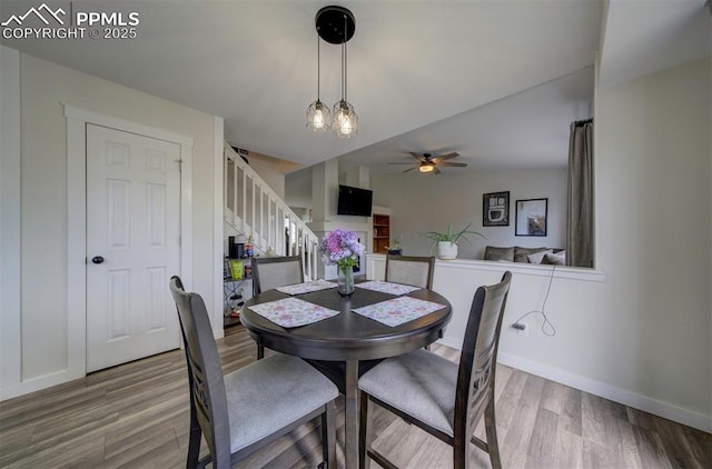 4530 W Jet Wing Cir, Colorado Springs, CO 80916 - dining room featuring stairs, wood finished floors, and a ceiling fan