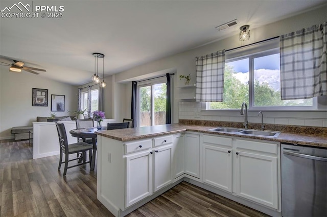 4530 W Jet Wing Cir, Colorado Springs, CO 80916 - kitchen featuring stainless steel dishwasher, dark wood-style flooring, and white cabinets