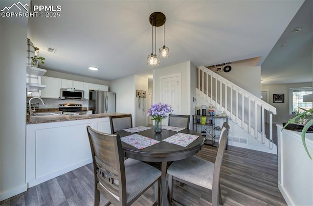 4530 W Jet Wing Cir, Colorado Springs, CO 80916 - dining space with stairway, dark wood-style flooring, and recessed lighting