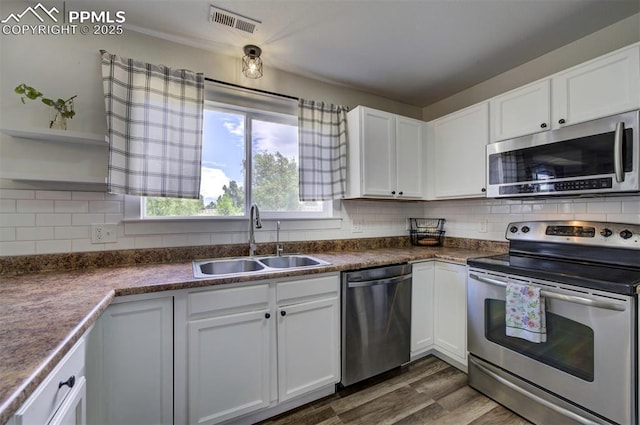 4530 W Jet Wing Cir, Colorado Springs, CO 80916 - kitchen with stainless steel appliances, open shelves, white cabinets, and tasteful backsplash
