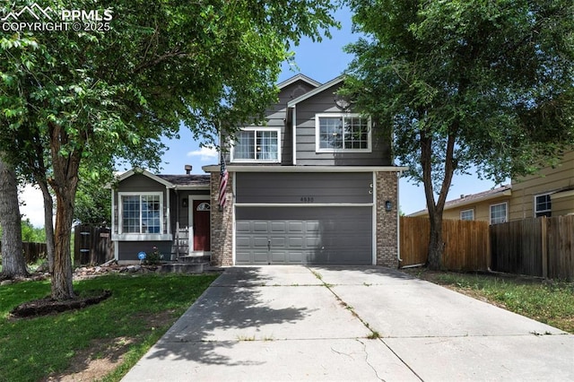 4530 W Jet Wing Cir, Colorado Springs, CO 80916 - traditional-style home with a garage, concrete driveway, and brick siding