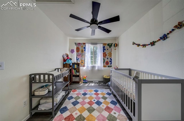 4530 W Jet Wing Cir, Colorado Springs, CO 80916 - bedroom featuring wood finished floors, a nursery area, and a ceiling fan