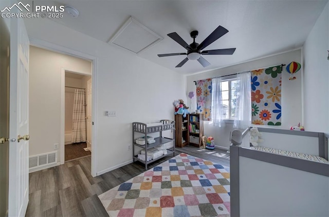 4530 W Jet Wing Cir, Colorado Springs, CO 80916 - bedroom with wood finished floors, a ceiling fan, and attic access