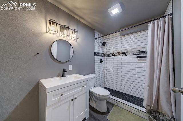 4530 W Jet Wing Cir, Colorado Springs, CO 80916 - bathroom with vanity, tiled shower, and a textured wall