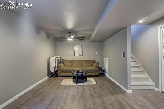 4530 W Jet Wing Cir, Colorado Springs, CO 80916 - unfurnished living room featuring a ceiling fan, wood finished floors, and stairway