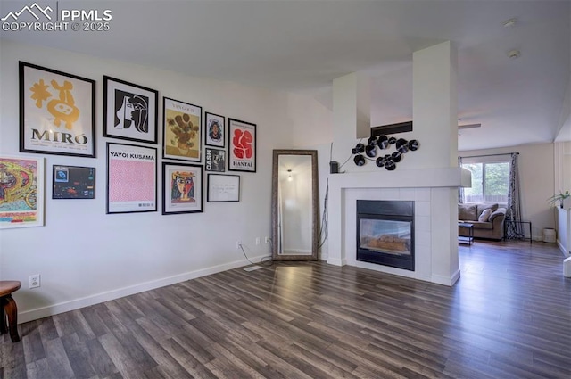4530 W Jet Wing Cir, Colorado Springs, CO 80916 - unfurnished living room featuring dark wood-type flooring and a tile fireplace