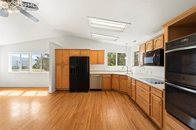 3970 Old Ranch Rd, Colorado Springs, CO 80908 - kitchen with black appliances, light countertops, light wood finished floors, vaulted ceiling, and a ceiling fan