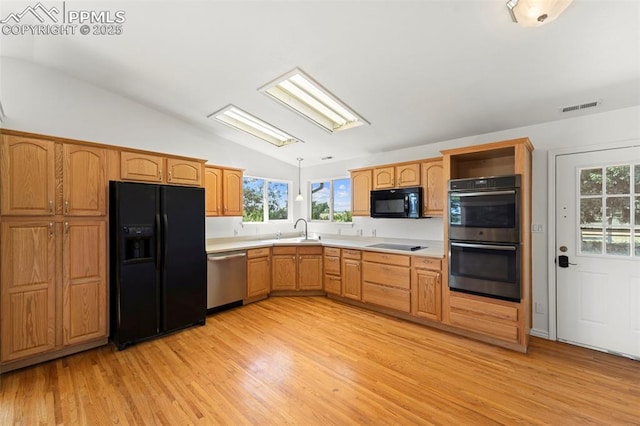 3970 Old Ranch Rd, Colorado Springs, CO 80908 - kitchen featuring black appliances, vaulted ceiling, light wood-style floors, light countertops, and open shelves