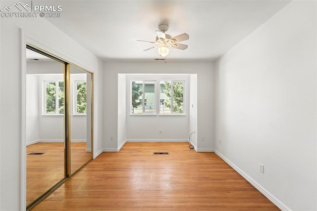 3970 Old Ranch Rd, Colorado Springs, CO 80908 - unfurnished bedroom with multiple windows, light wood finished floors, a closet, and a ceiling fan