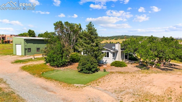 3970 Old Ranch Rd, Colorado Springs, CO 80908 - view of front of house with an outbuilding, a garage, and a chimney