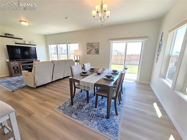 8136 Kittrick Pl, Peyton, CO 80831 - dining room with a chandelier, healthy amount of natural light, and light wood-style flooring