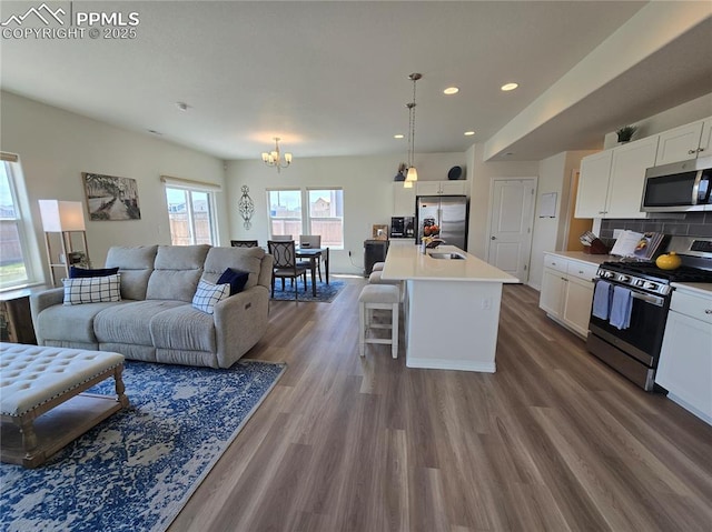 8136 Kittrick Pl, Peyton, CO 80831 - living area with a chandelier, recessed lighting, and dark wood-type flooring