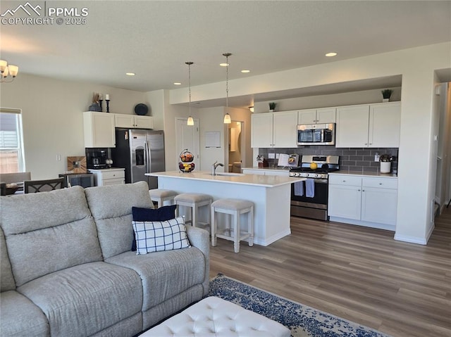 8136 Kittrick Pl, Peyton, CO 80831 - living area featuring wood finished floors, recessed lighting, and a chandelier