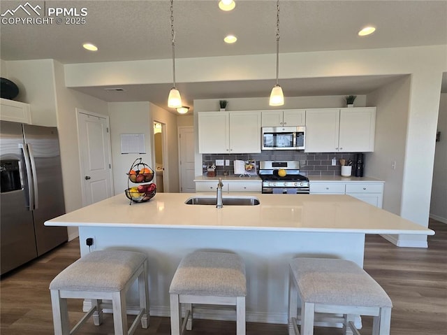 8136 Kittrick Pl, Peyton, CO 80831 - kitchen featuring appliances with stainless steel finishes, recessed lighting, backsplash, dark wood finished floors, and white cabinets