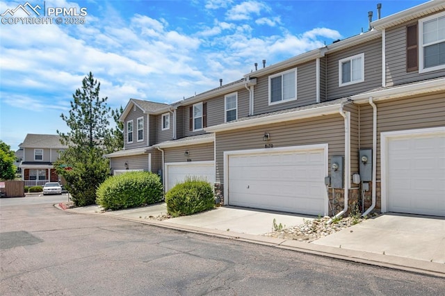 8170 Snow Bowl Hts, Fountain, CO 80817 - multi unit property with an attached garage, concrete driveway, and stone siding