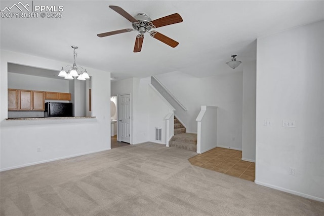 8170 Snow Bowl Hts, Fountain, CO 80817 - unfurnished living room featuring carpet flooring, a ceiling fan, stairs, and a chandelier