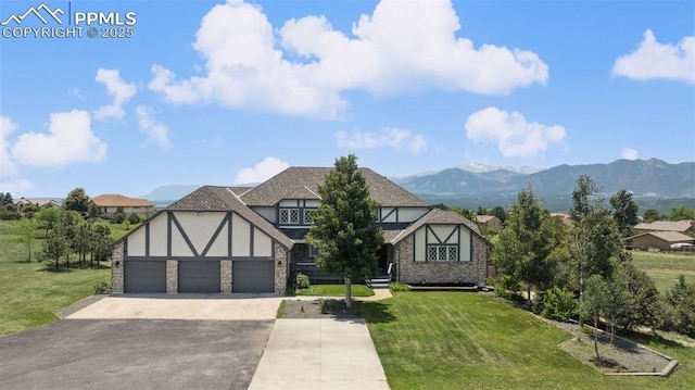 780 Mission Hill Way, Colorado Springs, CO 80921 - english style home with driveway, stone siding, a front yard, and stucco siding