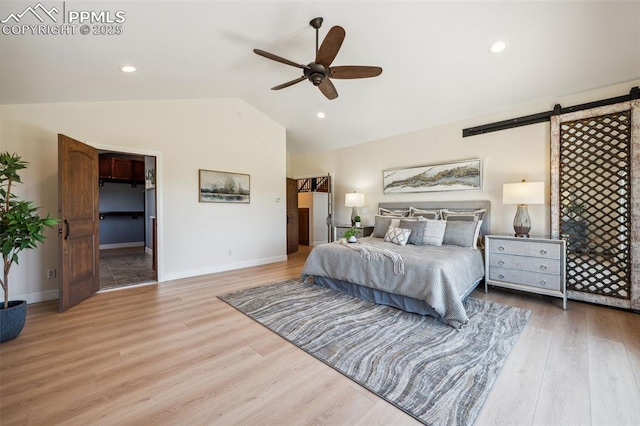 780 Mission Hill Way, Colorado Springs, CO 80921 - bedroom with a barn door, vaulted ceiling, wood finished floors, a ceiling fan, and recessed lighting