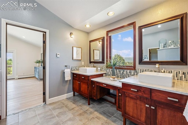 780 Mission Hill Way, Colorado Springs, CO 80921 - bathroom featuring vaulted ceiling, two vanities, a baseboard radiator, tile patterned floors, and recessed lighting