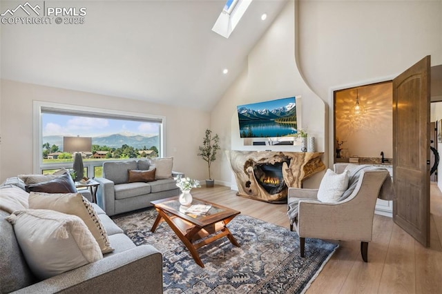 780 Mission Hill Way, Colorado Springs, CO 80921 - living room with high vaulted ceiling, light wood-type flooring, a skylight, a fireplace, and recessed lighting