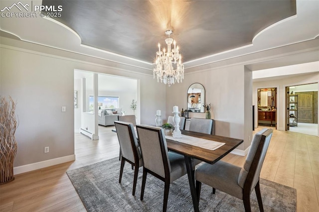 780 Mission Hill Way, Colorado Springs, CO 80921 - dining area with a tray ceiling, light wood finished floors, a chandelier, and crown molding