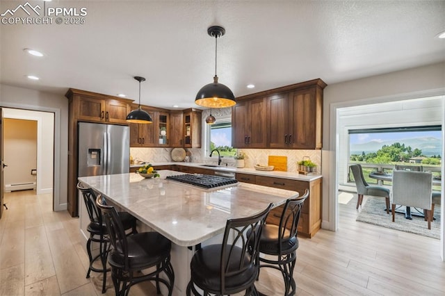 780 Mission Hill Way, Colorado Springs, CO 80921 - kitchen with stainless steel appliances, recessed lighting, baseboard heating, light wood-type flooring, and a kitchen island