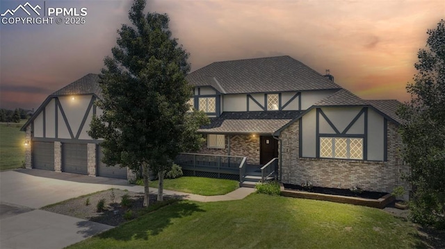780 Mission Hill Way, Colorado Springs, CO 80921 - tudor home with a yard, stucco siding, concrete driveway, and brick siding