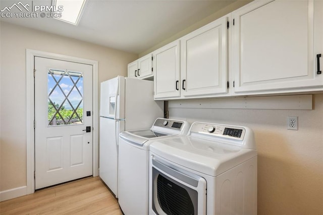 780 Mission Hill Way, Colorado Springs, CO 80921 - laundry area featuring washing machine and clothes dryer, cabinet space, and light wood finished floors