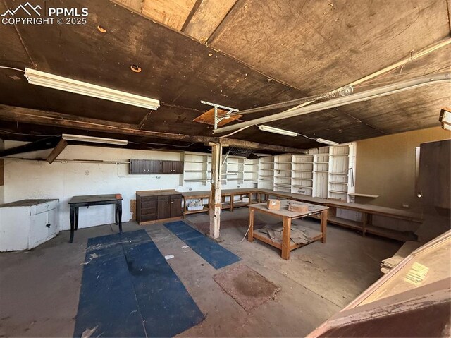 1117 E 6th St, La Junta, CO 81050 - misc room featuring a workshop area and concrete flooring