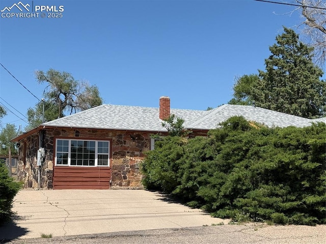 1117 E 6th St, La Junta, CO 81050 - view of front of property featuring stone siding and a chimney