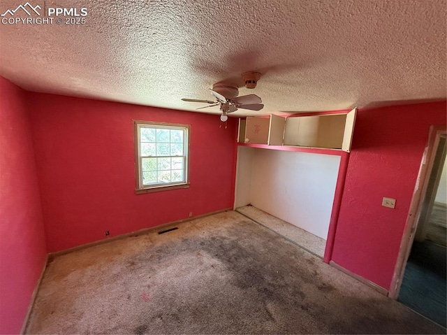 1117 E 6th St, La Junta, CO 81050 - unfurnished bedroom with a textured ceiling, carpet flooring, and a ceiling fan