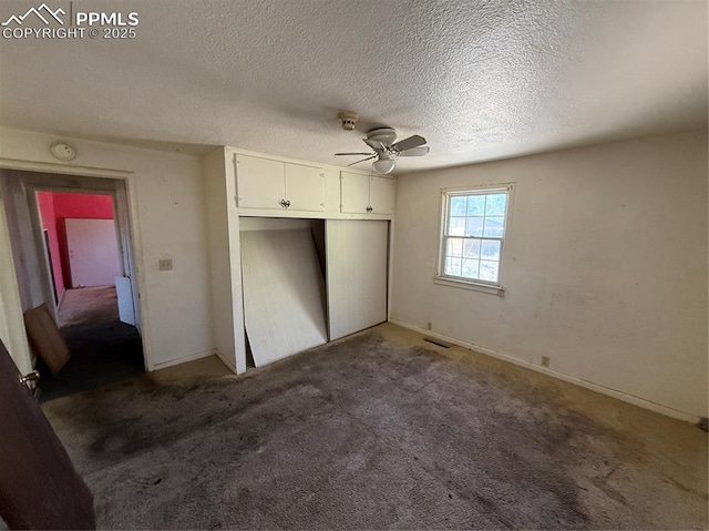 1117 E 6th St, La Junta, CO 81050 - unfurnished bedroom with a closet, a textured ceiling, carpet, and ceiling fan