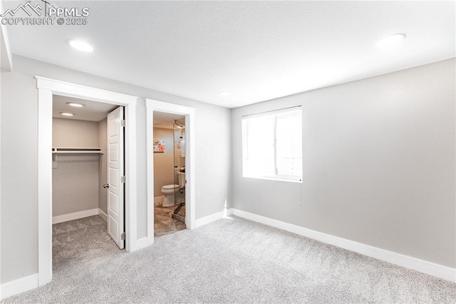 1514 W Platte Ave, Colorado Springs, CO 80904 - unfurnished bedroom featuring carpet floors, a spacious closet, a closet, connected bathroom, and recessed lighting