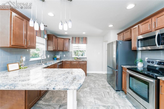1514 W Platte Ave, Colorado Springs, CO 80904 - kitchen featuring appliances with stainless steel finishes, backsplash, light stone counters, decorative light fixtures, and recessed lighting
