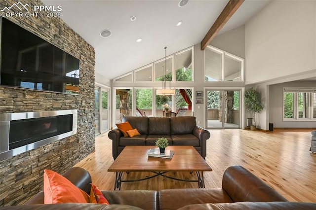 1282 Hill Cir, Colorado Springs, CO 80904 - living area featuring beam ceiling, high vaulted ceiling, hardwood / wood-style floors, a stone fireplace, and recessed lighting