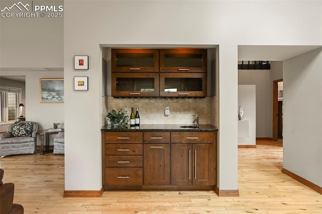 1282 Hill Cir, Colorado Springs, CO 80904 - indoor bar featuring light wood-type flooring and backsplash